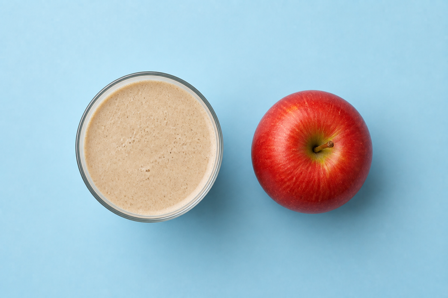 Protein shake beside a whole apple